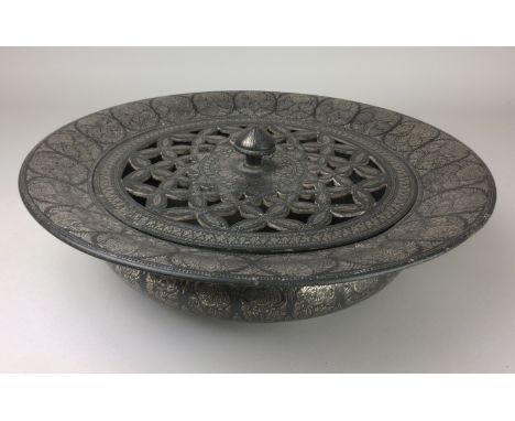 A 19th Century silver inlaid Bidri circular Basin and Cover, Deccan, The pierced cover with bud finial, broad everted rim abo