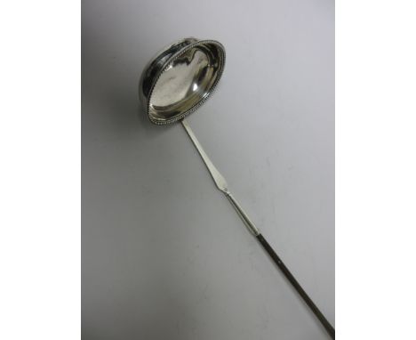 A George III silver Toddy Ladle with beaded oval bowl and spiral whalebone handle, Newcastle circa 1790, makers: Langlands & 