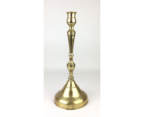 An Ottoman brass Candlestick,Turkey,slender baluster form on large conical foot, 16 1/2 in H