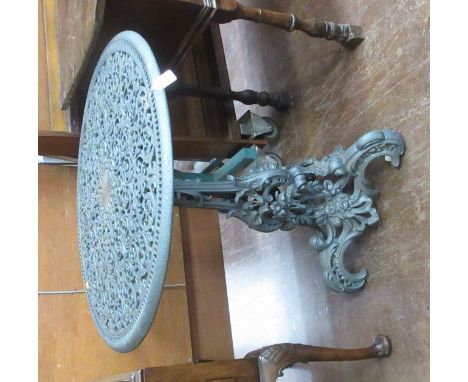 A Dutch rococo revival cast iron Garden Table after a design by L.I. Entoren, on floral scroll tripod base, 2ft 5in diam