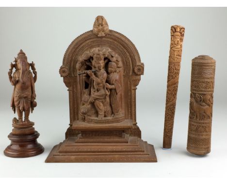 Four Indian carved wood items,Comprising a figure of Ganesha, a figure of Krishna playing his flute, a parasol handle carved 