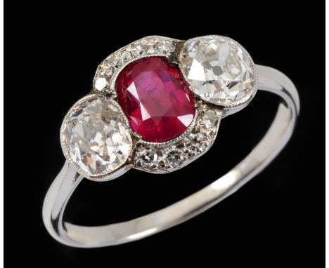 A Ruby and Diamond Ring millegrain-set oval-cut ruby between two old-cut diamonds within bands of eight-cut diamonds, ring si