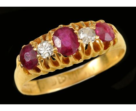 A Ruby and Diamond five stone Ring pavé-set oval-cut ruby between two old-cut diamonds and two cushion-cut rubies in 18ct gol