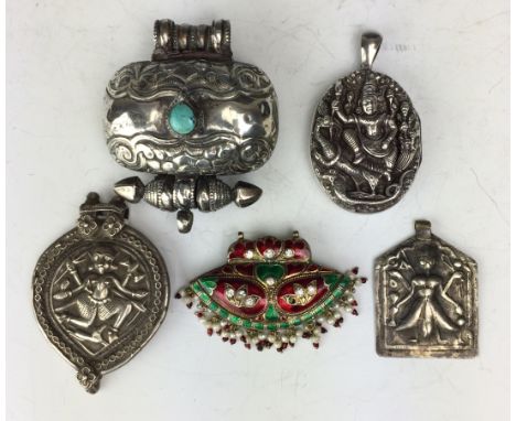 Five Indian white metal or enamel Pendants, Including a locket decorated with Kartikey with peacock and snake, a Ladakhi turq