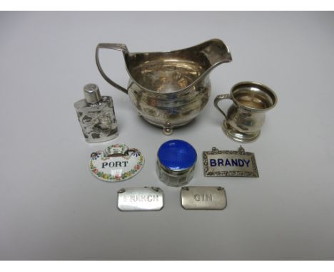 A George III silver oval Milk Jug with leafage engraving on ball feet, London 1814, a small baluster Measure, silver and enam