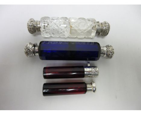 Two silver lidded ruby glass Scent Bottles, Birmingham 1897 and 1901 and two double-ended Scent Bottles in blue and clear cut
