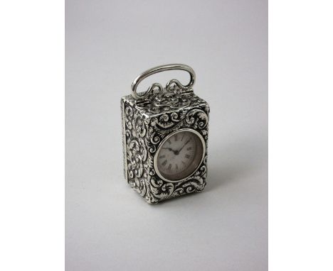 A Victorian silver cased small Carriage Clock with scroll embossing, London 1897, 3in