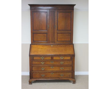 A 19th Century oak Bureau Bookcase inlaid and cross-banded in mahogany, the upper pair of doors enclosing shelves, the base w