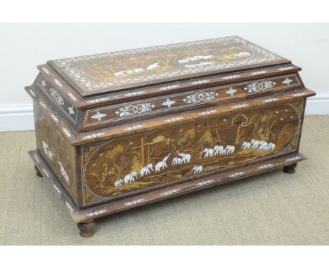An early 20th Century Anglo-Indian Padouk, ivory and marquetry trunk, Of sarcophagus form, the hinged lid and sides elaborate