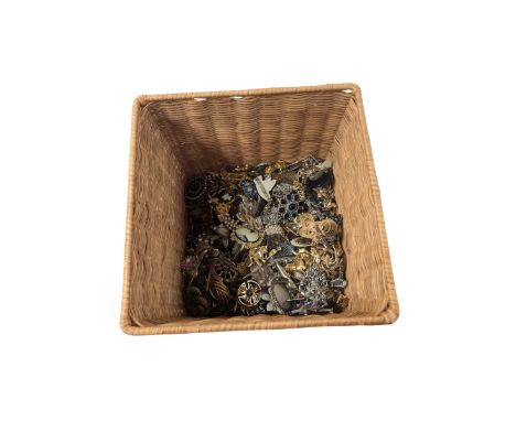 Collection of costume brooches, including ceramic, novelty and animal examples, contained within an wicker basket box