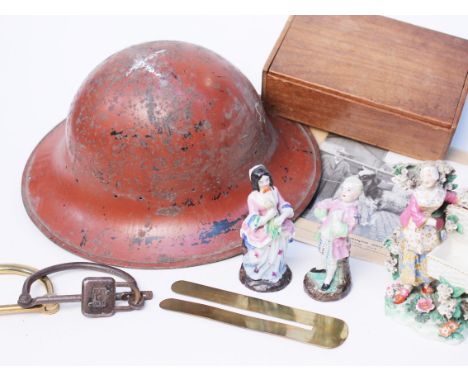 A mixed lot comprising a WWI tin helmet, a photograph of a prize dairy cow, two handcuffs, pottery figures etc.