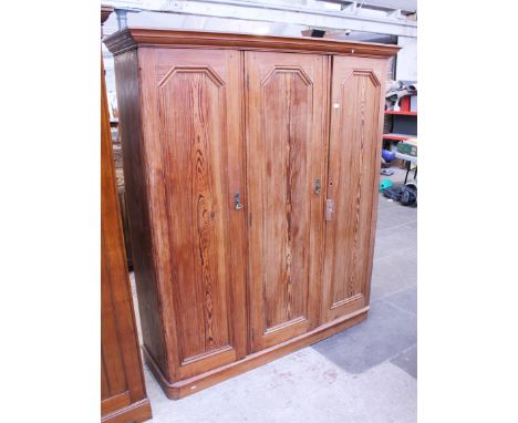 A three door pitch pine wardrobe