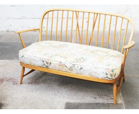 An Ercol light elm and beech two seater settee. L131cm