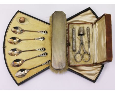 A mixed lot comprising a set of art deco hallmarked silver and enamel spoons, a hallmarked silver backed brush, a sewing set 