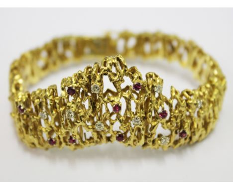A ladies 18ct gold, diamond and ruby bracelet. Circa 1970. L19cm. Gross wt. 54g