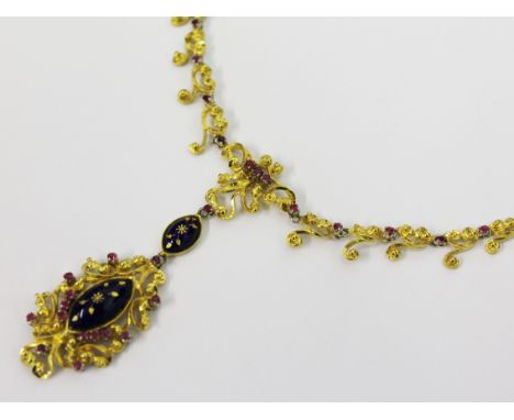 An 18ct gold blue enamel and ruby pendant necklace. Pendant Length 4.5cm. Gross wt.29.5g
