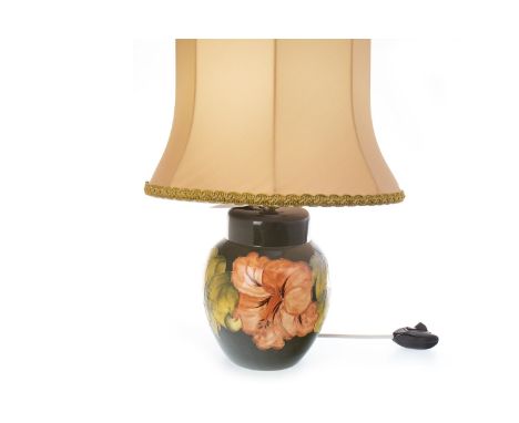 MOORCROFT 'HIBISCUS' PATTERN LAMP BASE, of oviform, tube-lined with flowers on a green ground, 20.5cm high, with shade