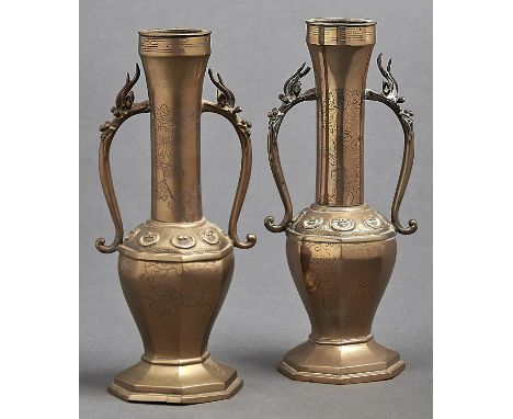 A pair of Chinese brass vases, third quarter 19th c, the tall tubular necks spreading at the top and applied pair of scrollin