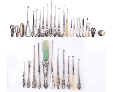 A collection of sixteen silver handled button hooks, embossed with flowers, palmettes, winged cherubs, spirally fluted exampl