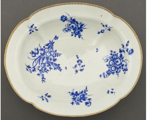 A Worcester dish, c1770, of lobed oval shape on flared foot, painted in 'Dry Blue' enamel with bouquets and scattered sprigs,