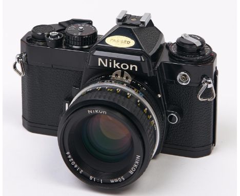 A Nikon FE SLR 35mm camera, with Nikon Nikkor 50mm F1.8 lens  In apparently working order, good condition. Lens a little dust