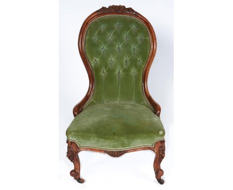 A Victorian walnut nursing chair, c1870, the top rail carved with flowerheads and leafage on a matted ground, buttoned back a