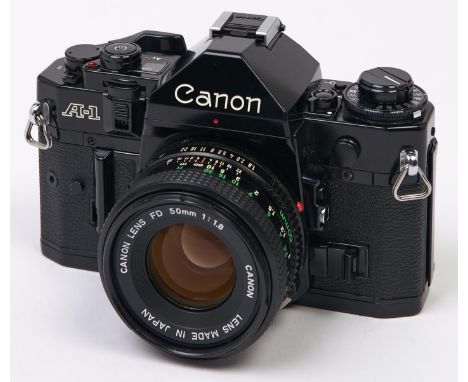 A Canon A-1 SLR 35mm camera, with Canon FD 50mm F1.8 lens  In apparently working order, good condition, lens could benefit fr