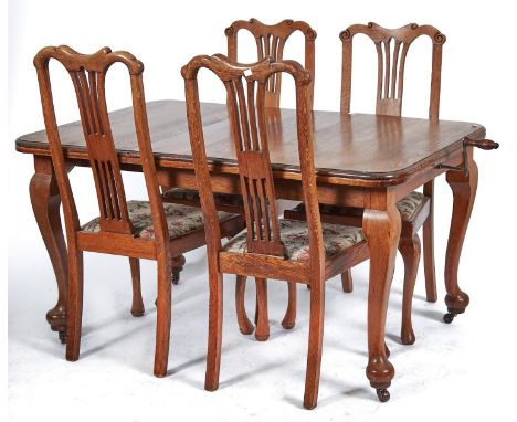 An oak single leaf extending dining table, c1930's, the rounded rectangular top above cabriole legs with pad feet, fitted cer