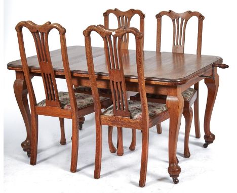 An oak single leaf extending dining table, c1930's, the rounded rectangular top above cabriole legs with pad feet, fitted cer