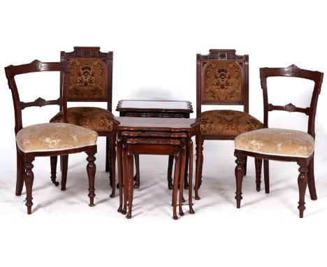 A pair of Victorian walnut framed dining chairs with concave backs with incised decoration, the horizontal rail conforming, s
