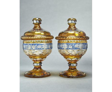 A pair of Bohemian cut and blue and amber flashed glass sweetmeat jars and covers, early 20th c, the facets outlined in blue 