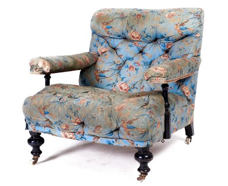 A Victorian ebonised open armchair, late 19th c, in the original light blue ground rose and bird pattern buttoned chintz, pot