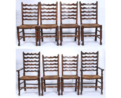 A set of eight ash ladder back dining chairs with graduated wavy horizontal rails, rush seats on turned legs joined by turned