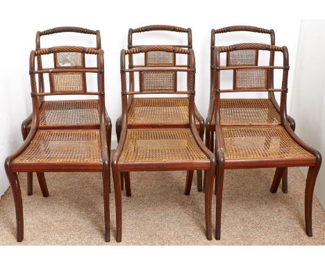 A set of six George IV caned mahogany and line inlaid dining chairs, with rope crest rail, caned tablet centred back rail and