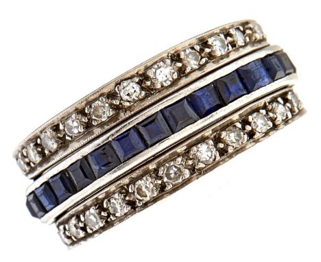 A ruby, sapphire and diamond reversible ring, with calibre cut rubies and sapphires and hinged diamond wings, in platinum col