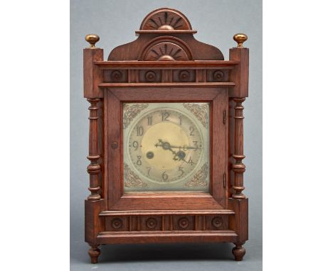 A Victorian&nbsp;oak cased mantel clock, c1890, with arched pediment and bun shaped lacquered brass finials, the frieze appli