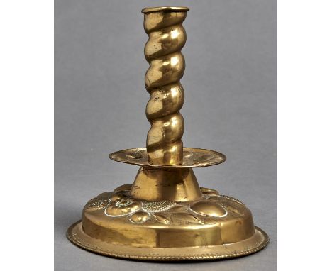 A Flemish sheet brass candlestick, 19th c, in 17th c style, with spiral pillar,&nbsp; repousse drip pan and domed, stepped fo