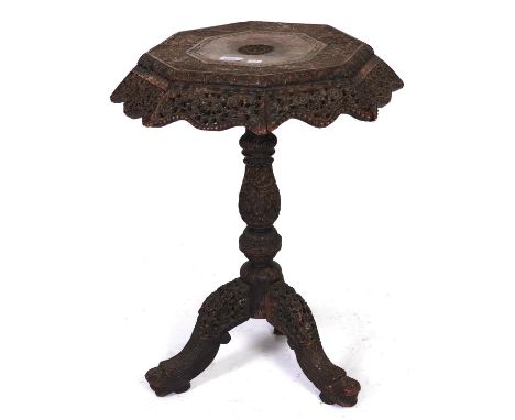 An Anglo-Indian carved and pierced black wood tripod table, Bombay (Mumbai), late 19th c, the octagonal top with floral apron