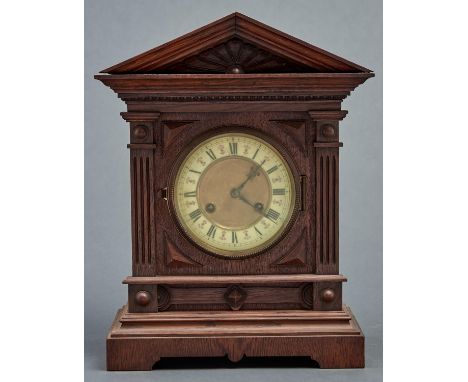 A late Victorian oak&nbsp; mantel clock, c1890, the flared architectural pediment with radiating fluted frieze, egg and dart 