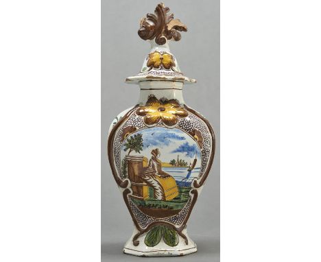 A Dutch polychrome Delft ware vase and cover, c1770, the vase with moulded cartouche and painted with a woman seated by a ped