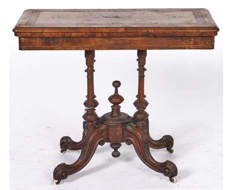 A Victorian inlaid walnut folding card table, with quarter veneered top, turned and carved pedestal base on white pottery cas