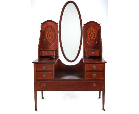 An Edwardian mahogany dressing table, c1905, the super structure with pair of inlaid ovals and short drawers supporting a bev