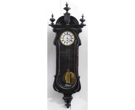 A Continental ebonised wall clock, late 19th c, the flared cornice with arched pediment centred on a fluted tablet and finial