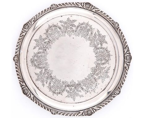 A Victorian gadrooned silver salver, the field engraved with a border of flowers and strapwork, on three vestigial feet, 27cm