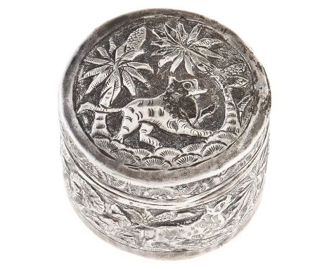An Indian silver repousse round box and cover, c1900, decorated with tiger, elephants and trees, 40mm diam, 17dwts  Polish re