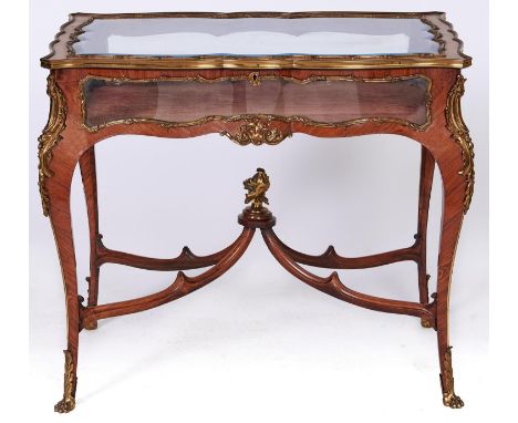 A French ormolu mounted kingwood display table, late 19th c, in Louis XV style, with bevelled glass to the hinged top, velvet