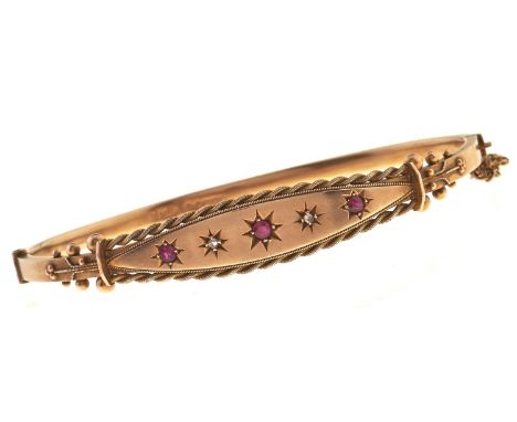 An Edwardian ruby and diamond bangle, gipsy set in 9ct gold, 66mm, maker CMW, Chester, date letter rubbed, possibly 1902, 7g 
