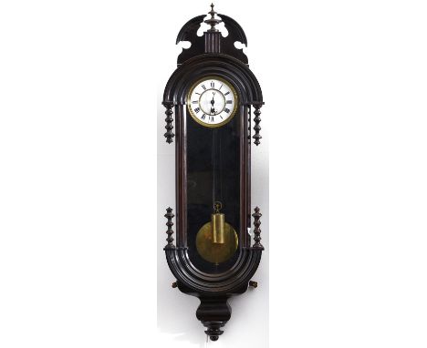 A mahogany-stained Continental wall clock, c1880, arched moulded case with ornate cornice with turned compressed ball and spi