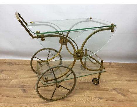 Stylish vintage brass framed and glass drinks trolley with twin demi-lune shaped flaps, under-tier and four wheels, 83cm long