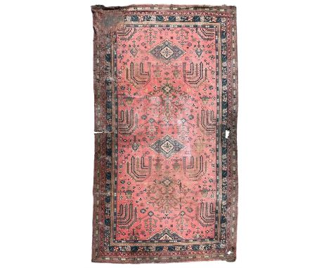 Large early 20th century Turkish red ground carpet, the field decorated with stylised plant motifs, multiple band border deco
